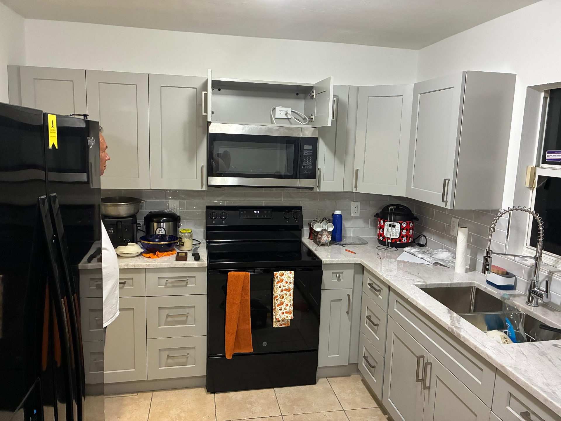 Gray kitchen cabinets with appliances installed