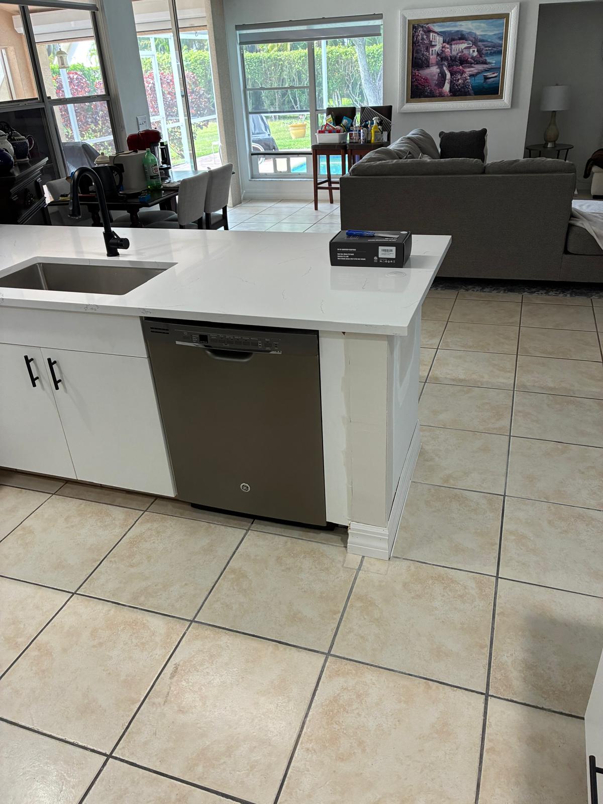 Modern white kitchen remodel with quartz island in a Naples, Florida home