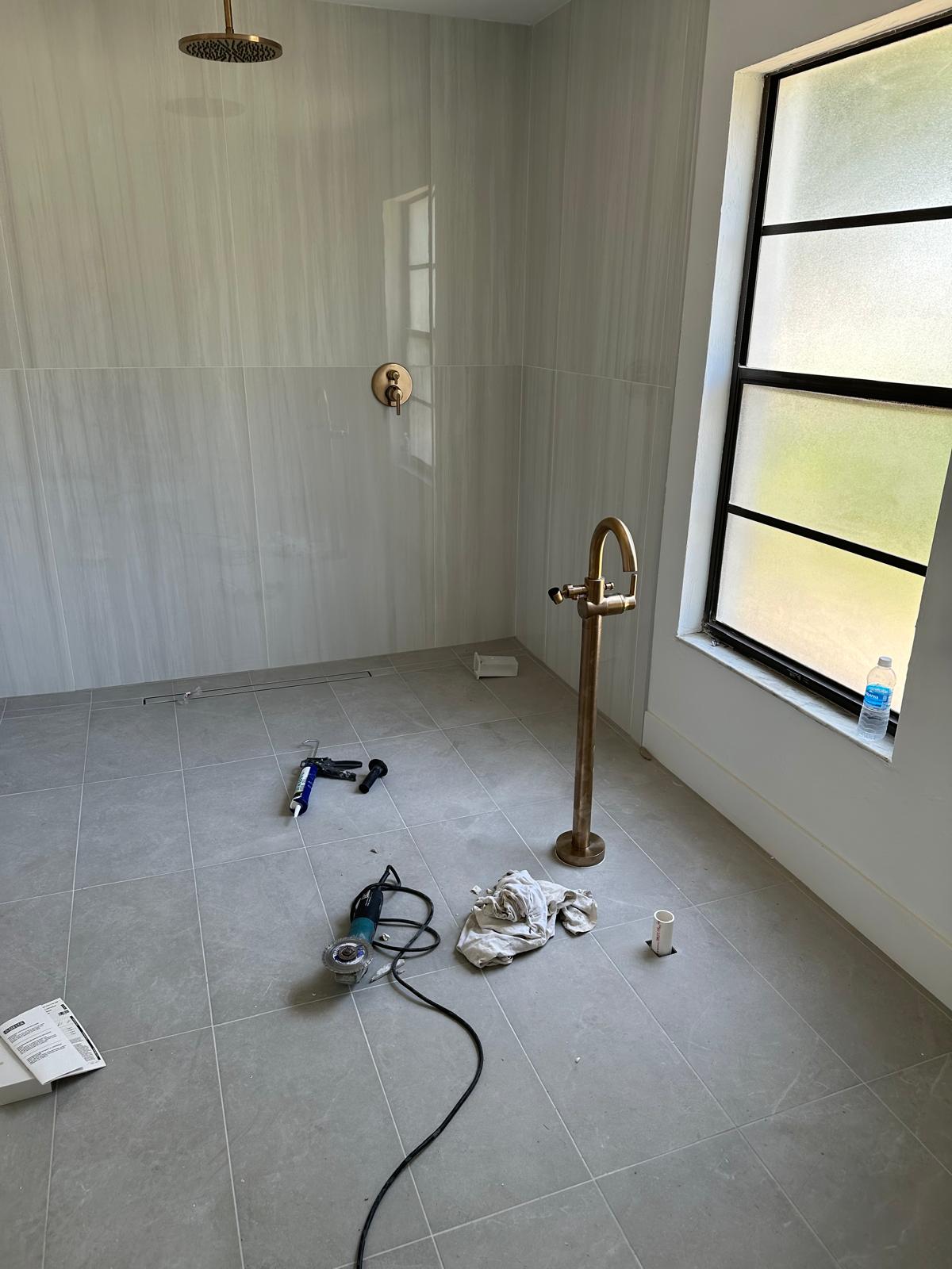 Walk-in shower with gold rain head