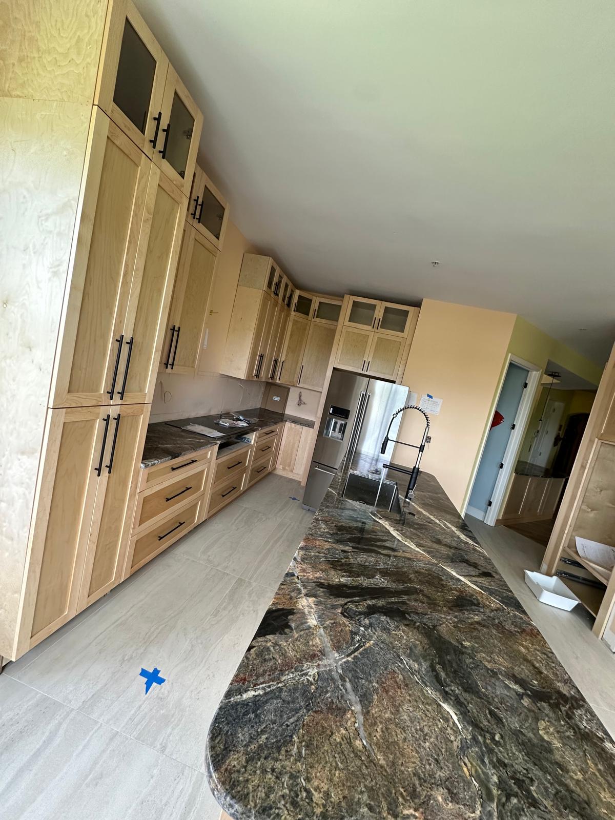 Natural wood cabinets with marble countertop in Naples